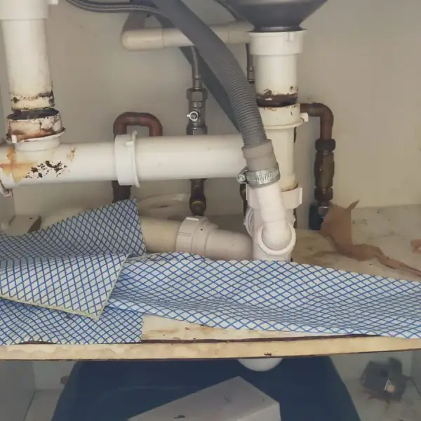 Kitchen waste trap under a sink before the pipework was renewed