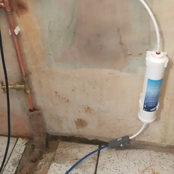 Fridge freezer water supply run in a chased channel along the floor