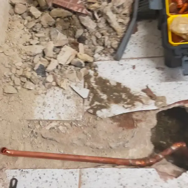 Copper supply pipe laid into the floor for a fridge freezer water feed