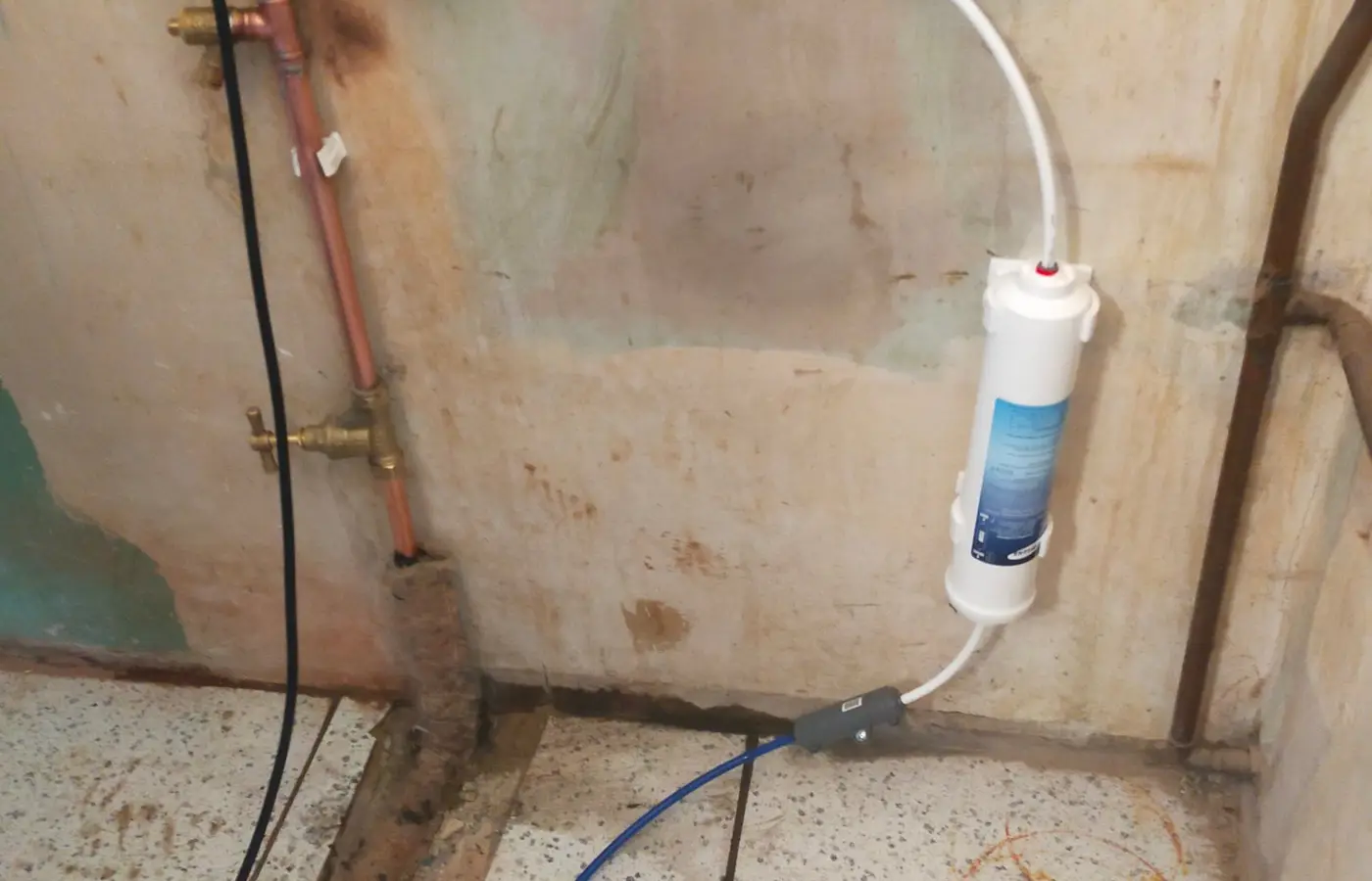 Fridge freezer water supply run in a chased channel along the floor